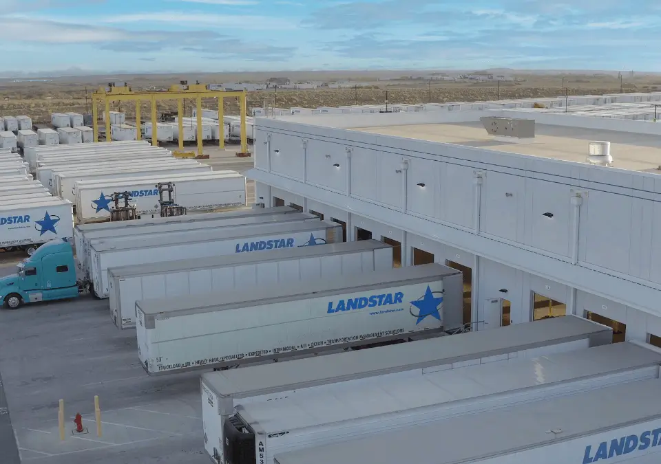 A large semi truck in motion, highlighting its powerful build and extensive cargo capacity on the highway.